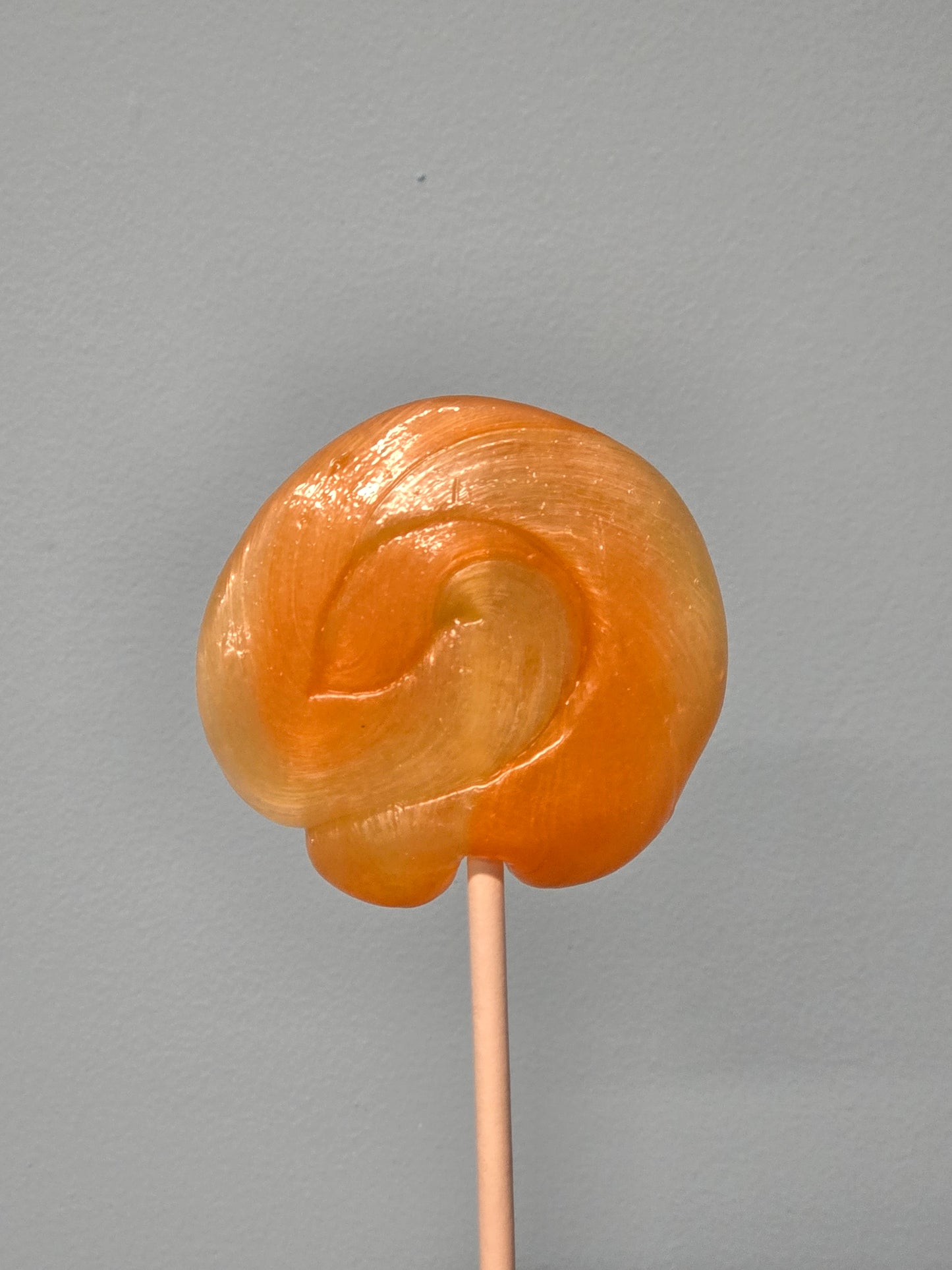 Vegan handmade tangerine swirl lollipops